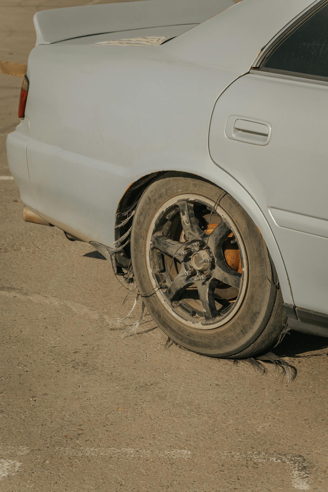 Car tire damage due to misalignment and suspension failure