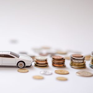 white car and stacked coins