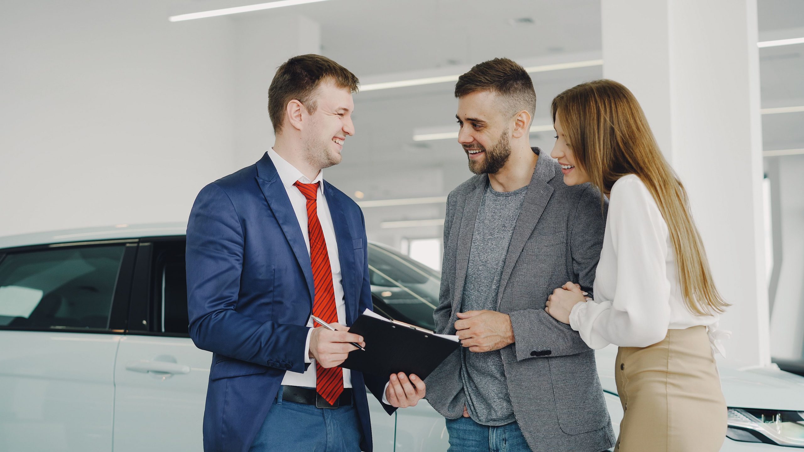 couple buying a car in a car dealership